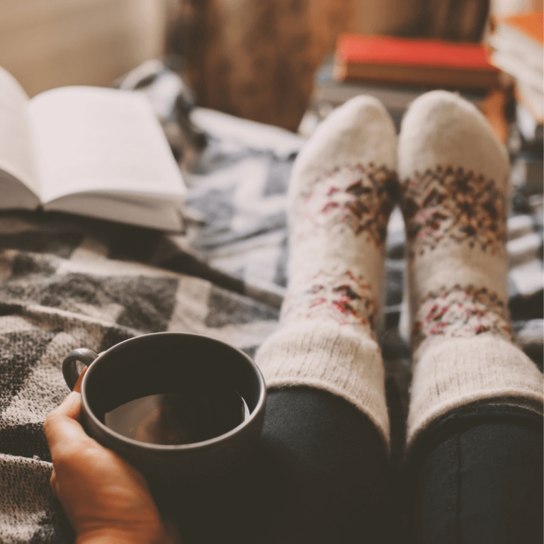 Holding a hot cup of coffee and wearing white socks with red pattern